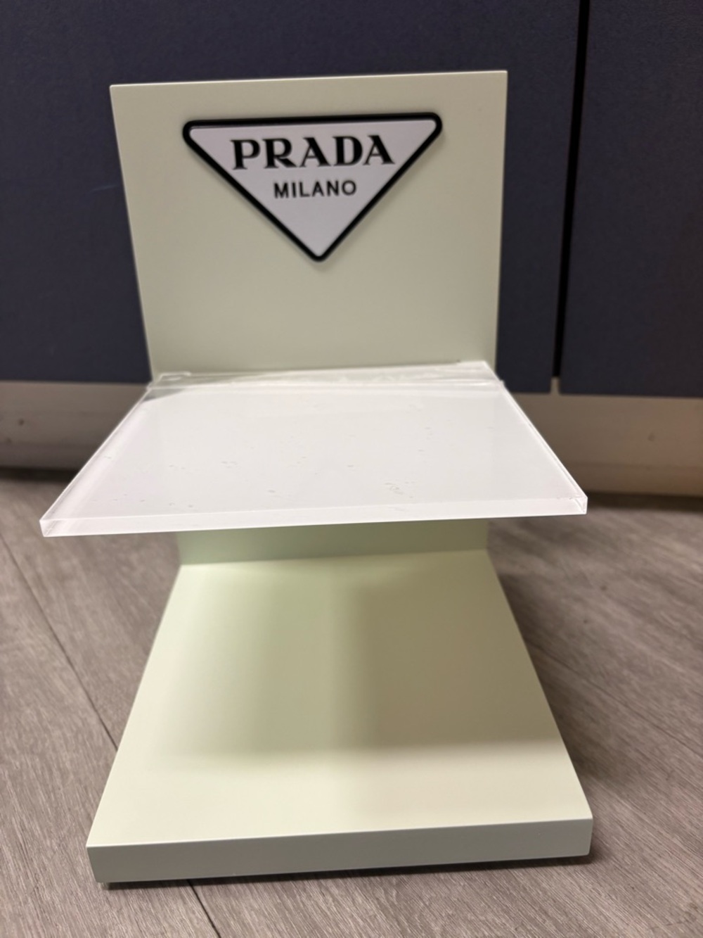 Prada pale mint tabletop display with white acrylic shelf